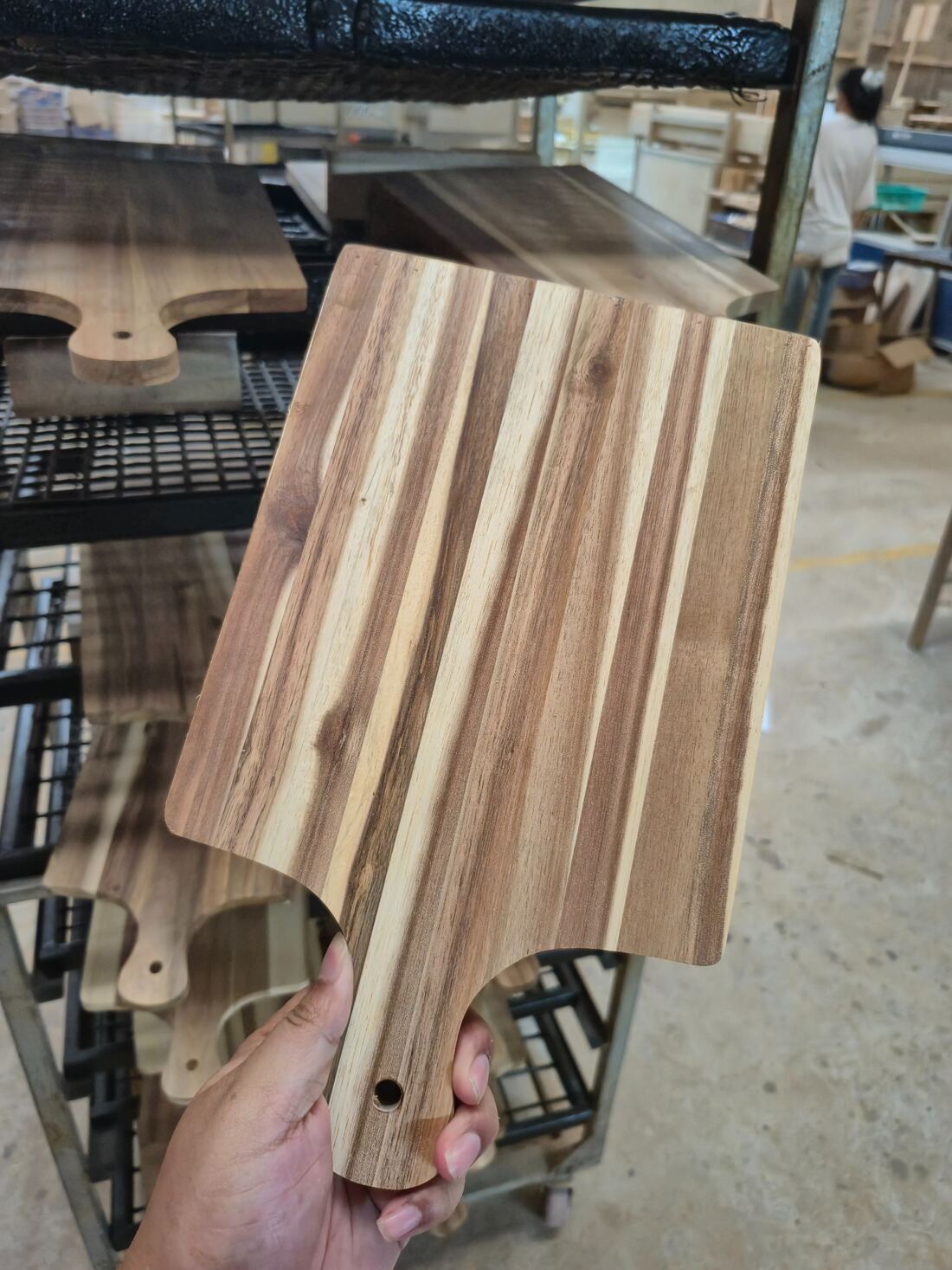 Custom wooden paddle board sample showing grain pattern and handle profile in our factory