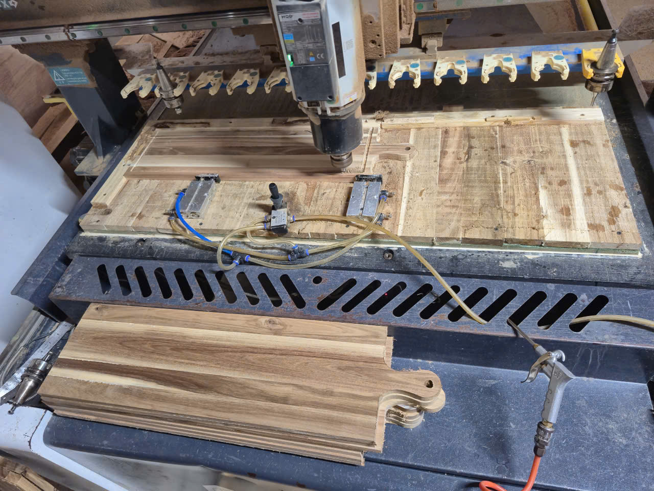 Wooden cutting boards being CNC machined to custom shapes